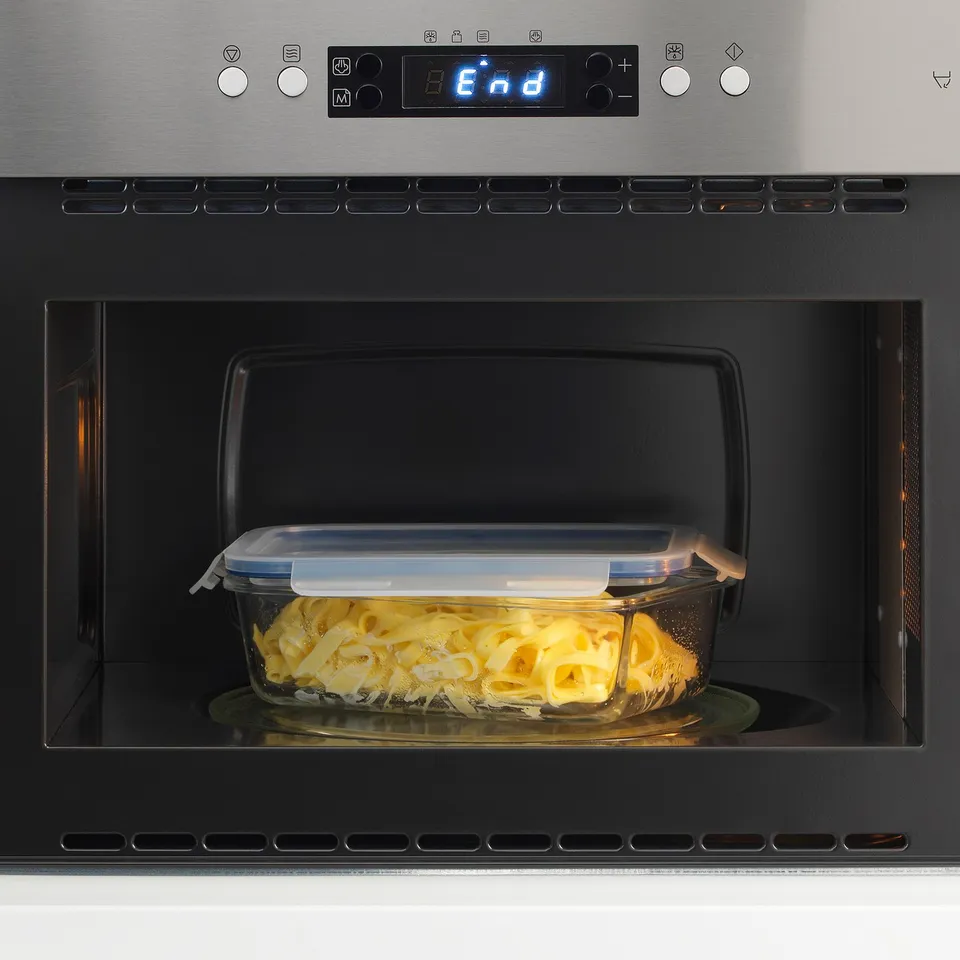 Glass food container in microwave. Lid is locked for secure heating.