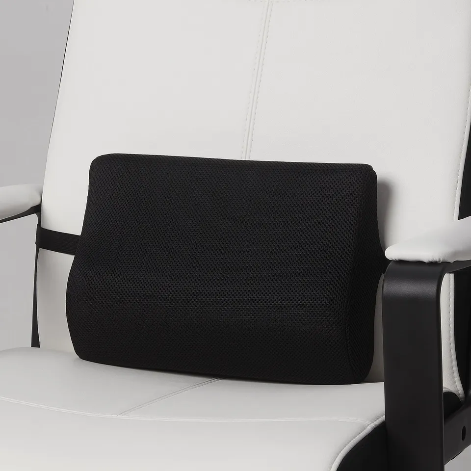 Black lumbar support pillow attached to white office chair, aiding back support and comfort.