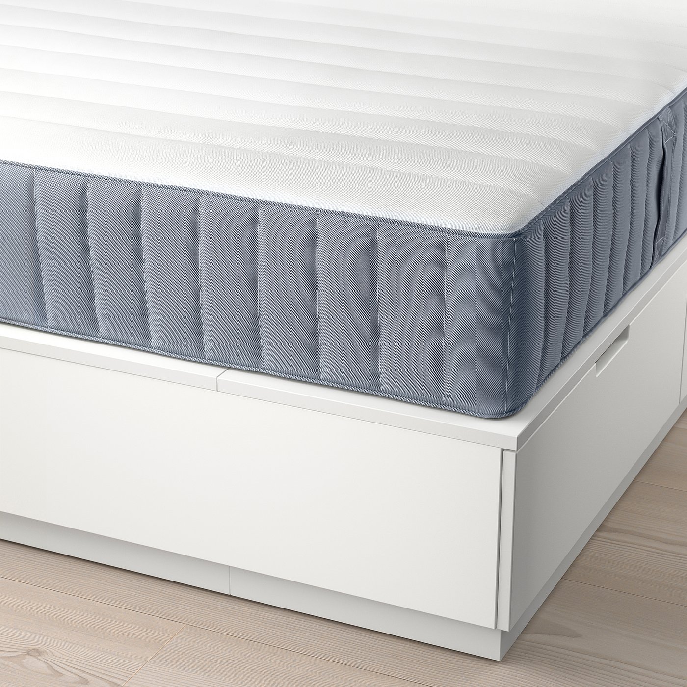 Image depicts a NORDLI bed frame with a white, striped mattress and six storage drawers, ideal for space-saving.