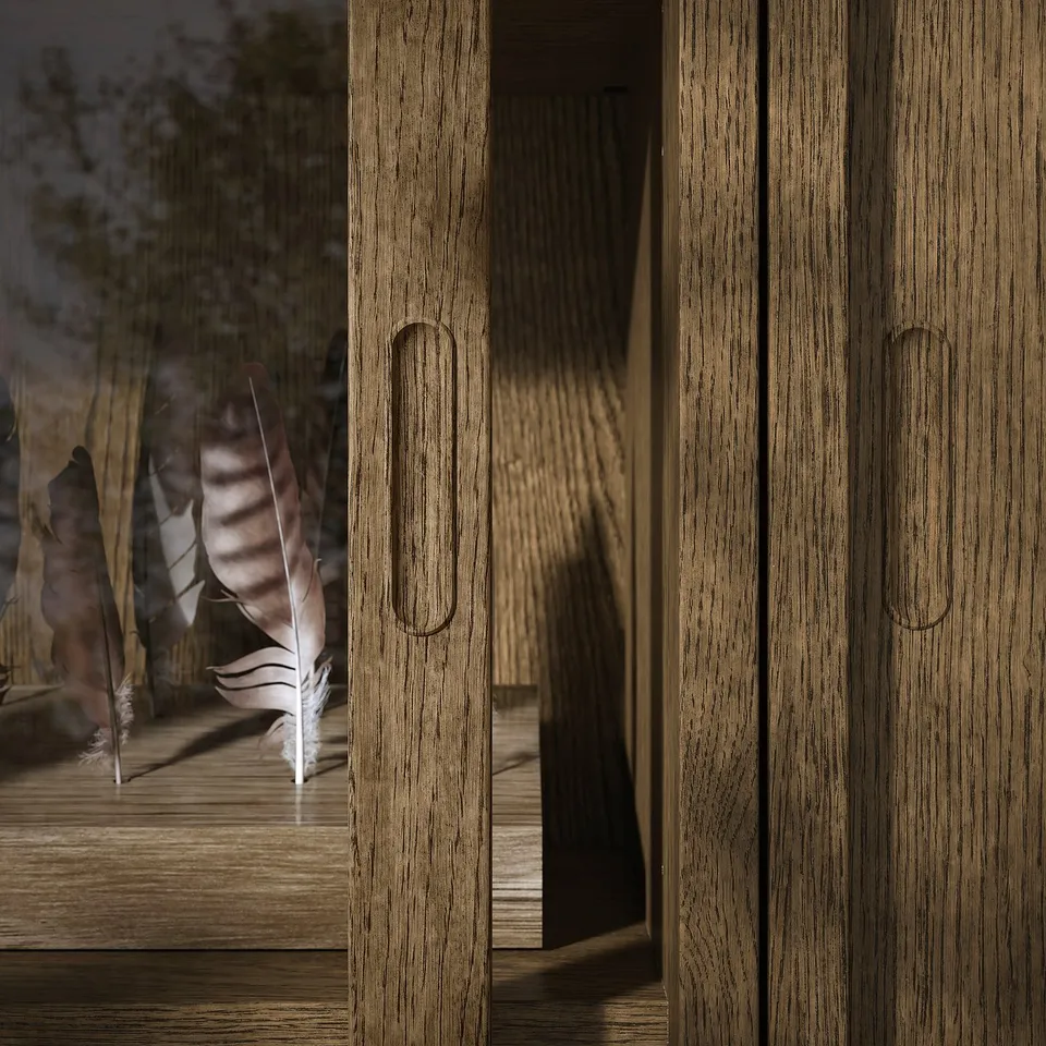 Oak veneer cabinet with sliding doors and oval handles, outdoors with a feather.