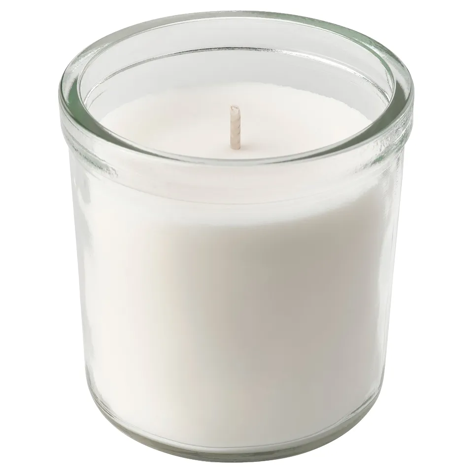 Cylindrical white candle in clear glass holder.