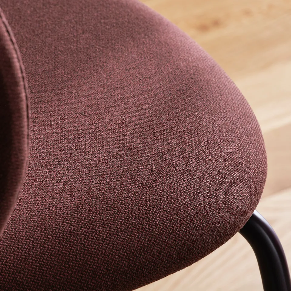 Close-up of plush, brown fabric chair seat, showcasing its soft texture and high-quality material.