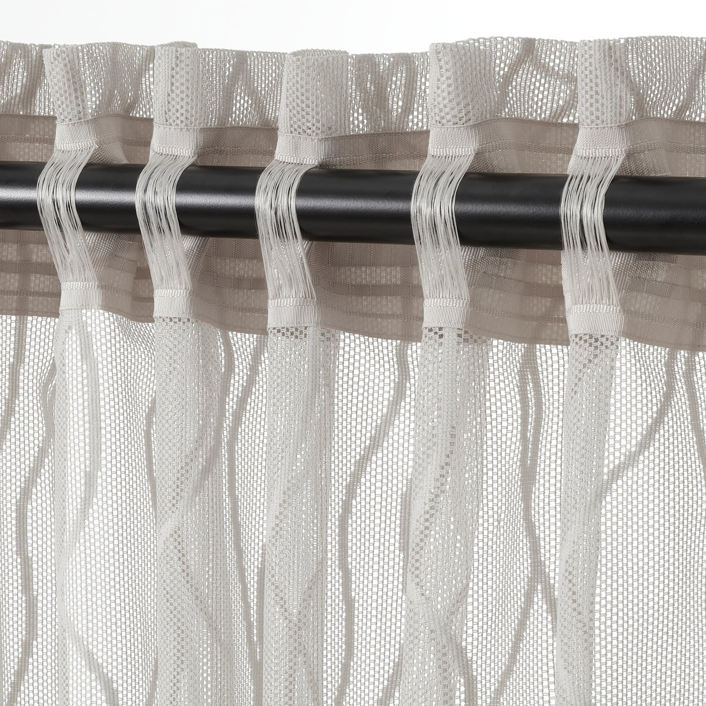 Sheer wave-patterned grey curtains on black rod, offering privacy and light.