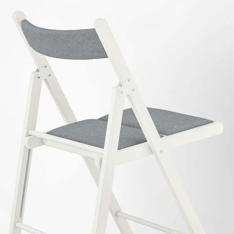 Modern white folding chair with grey cushioned seat and back, designed for comfort and space efficiency.