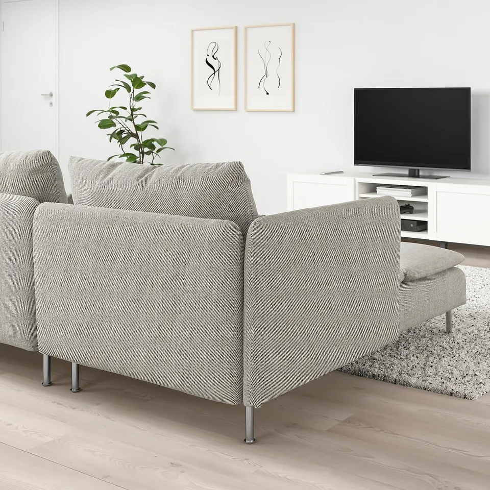 A SÖDERHAMN sectional sofa with light fabric, slim lines, and high legs, enhancing a minimalist, airy room with wooden flooring and a chaise longue.