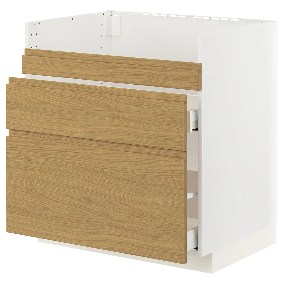 An ikea METOD kitchen cabinet in white and oak. It has integrated handles and is part of the voxtorp series.