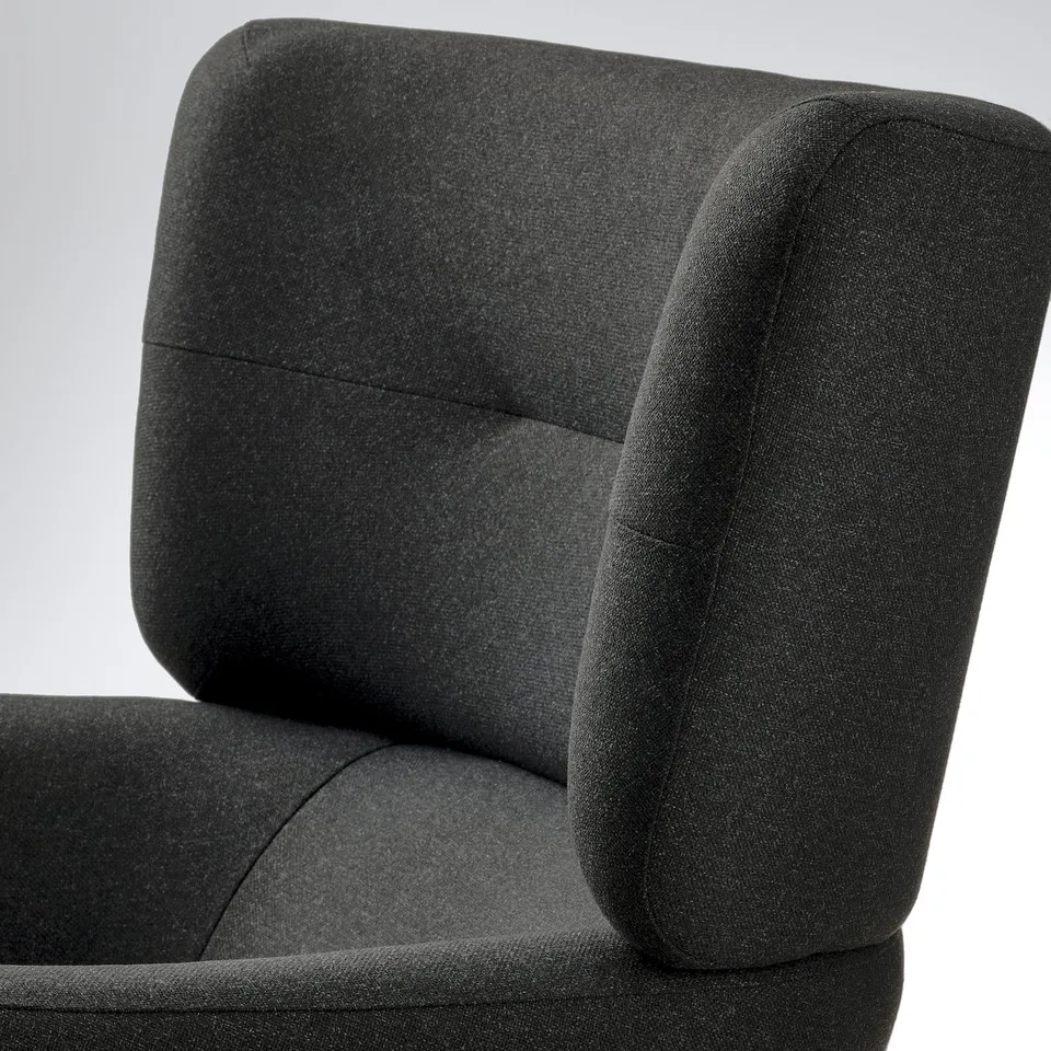 Close-up of modern chairs cushioned headrest and armrest detail. Dark fabric, clean lines, high back.