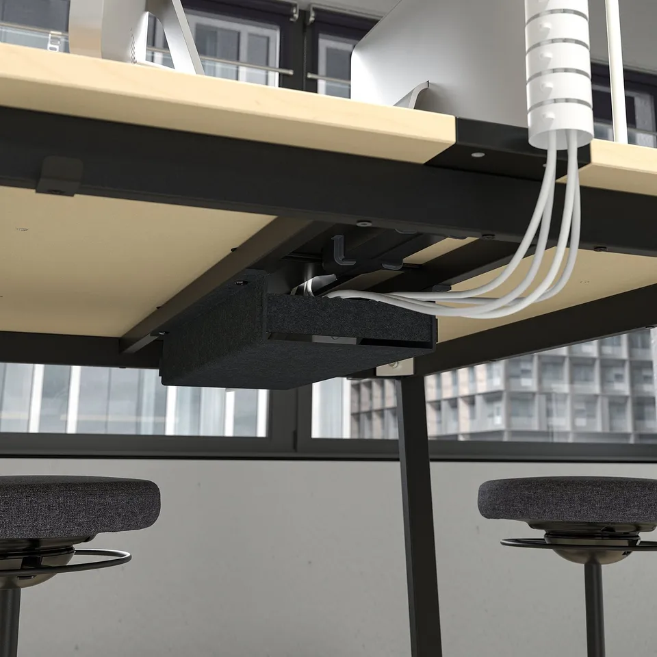 Under-desk cable management system with footrests and hooks for neat organisation.