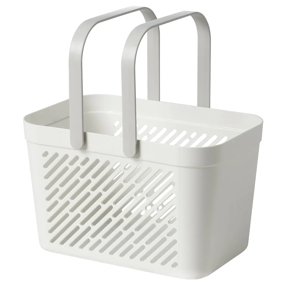 A white RÅNEN plastic shower basket with foldable handles, designed for storing bathroom essentials. It has holes for drainage and drying.