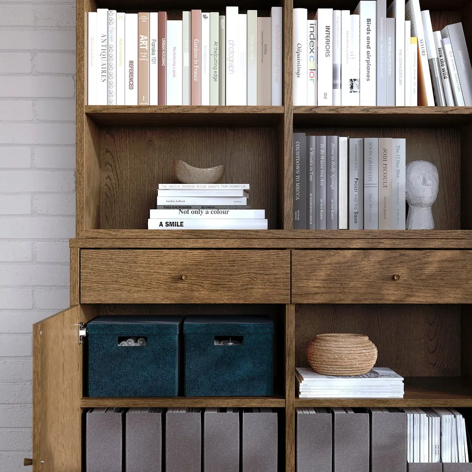 Wood bookshelf with books, decorative items, and storage bins. Shelves adjustable.