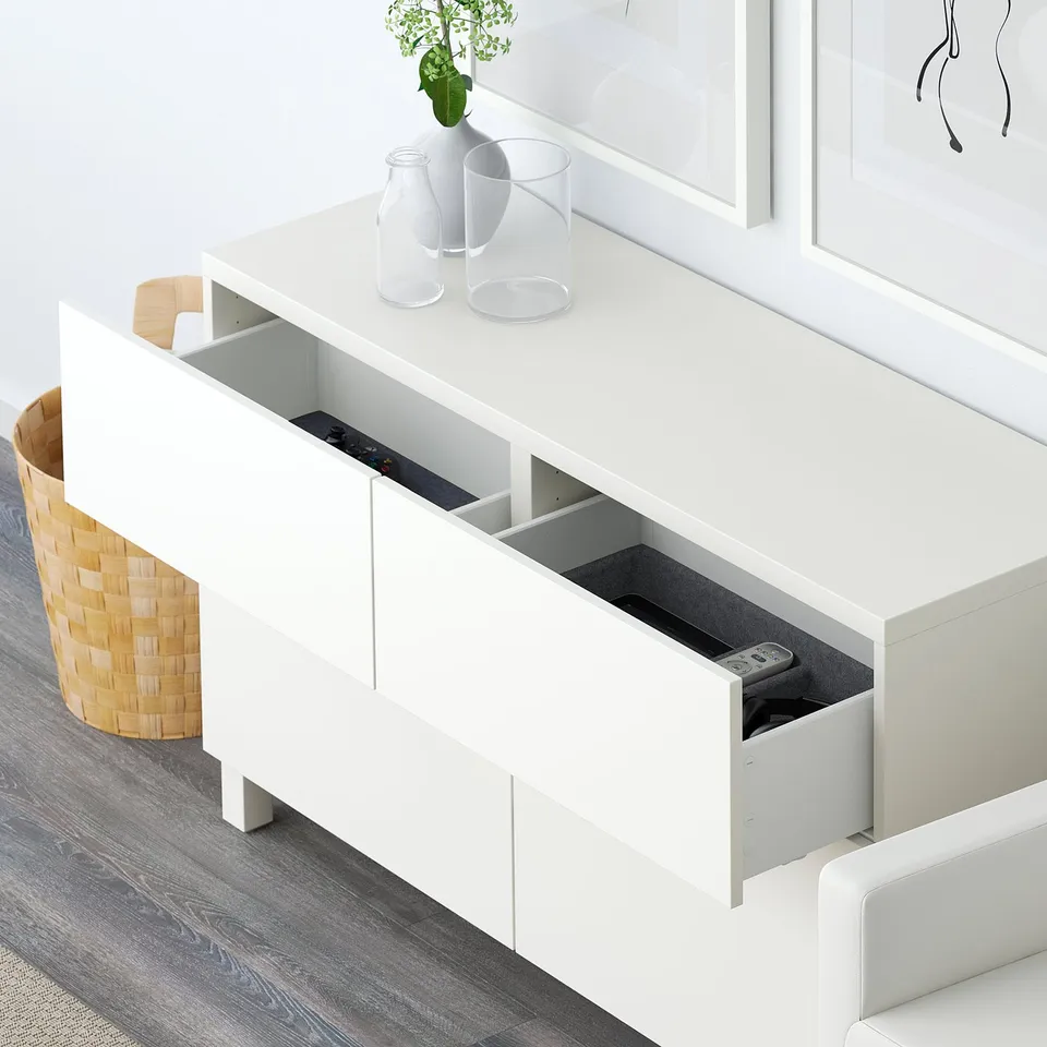 Modern white sideboard with compartments and drawer for remote storage, enhancing organisation in living spaces.