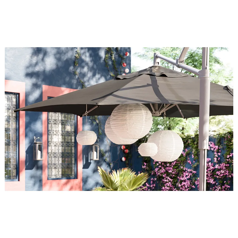 SOLVINDEN solar lamps on umbrella with glowing lights.