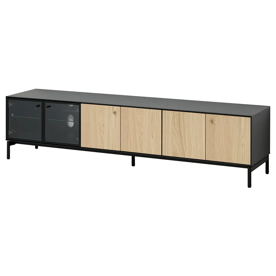 Long, black tv stand with wood doors and glass panels, sleek design.