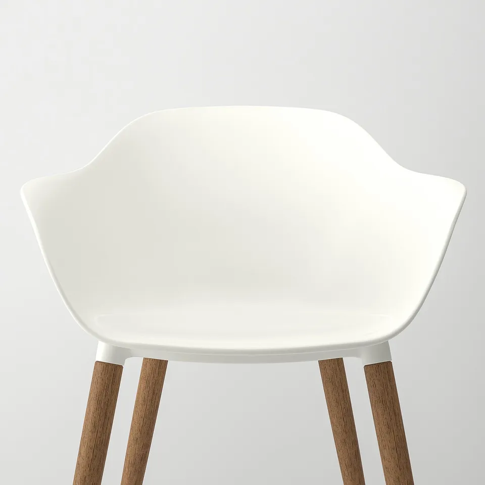 Modern white chair with curved seat and armrests, four wooden legs.