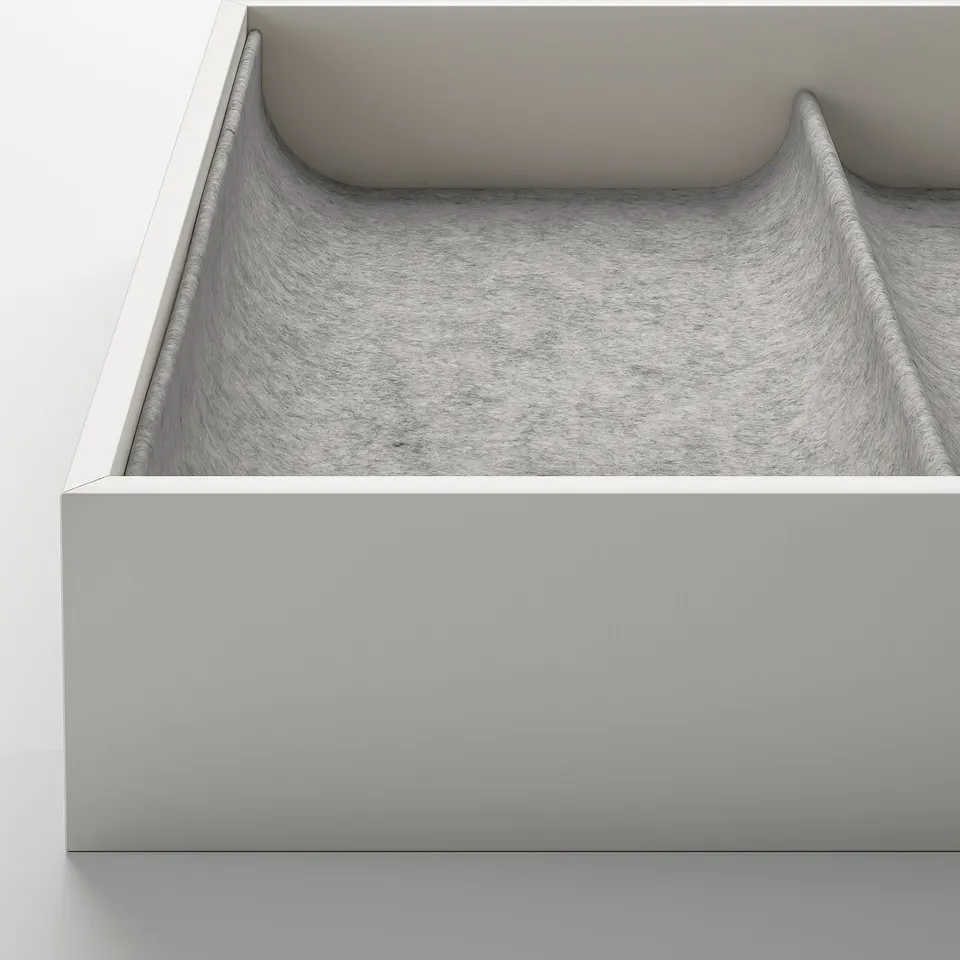 Image displays a modern pull-out drawer organiser with gentle, curved compartments, showcasing high-quality design and materials.