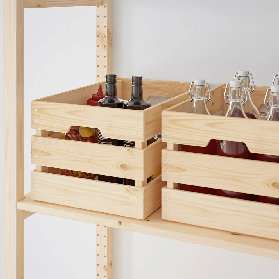 Wooden storage crates on shelves, holding bottles and cans, showcasing durable and versatile organisation.