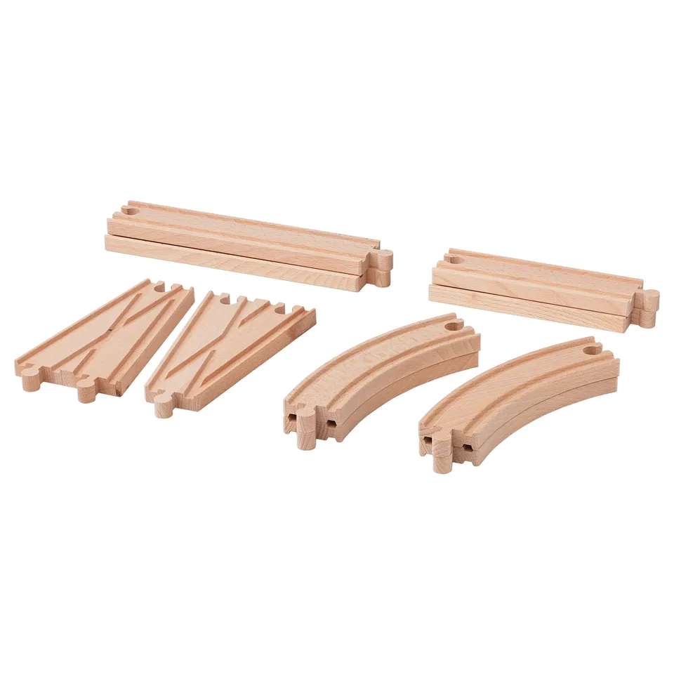 Wooden train tracks pieces in natural beech. Includes curved and straight sections, joint pieces, and connectors. Made from solid beech wood.