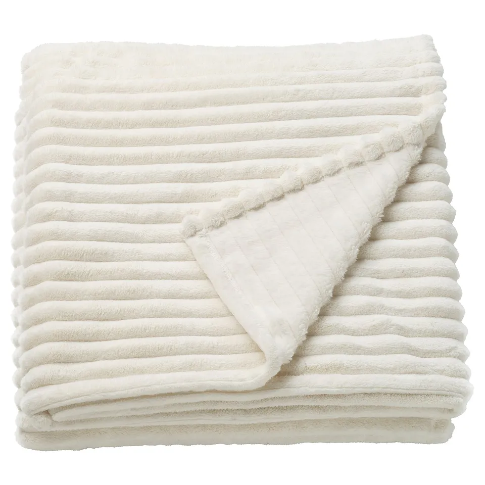 Ikea GULLSTRÅLE, cream-colored blanket, soft and fluffy, rectangular, folded neatly, shows stitching details.