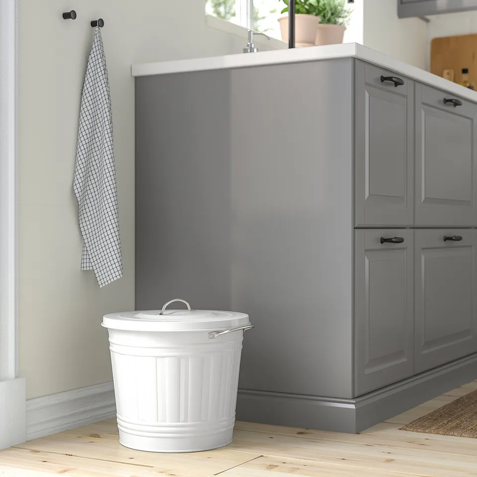 White KNODD bin near grey cabinet, fits under, handles, lid hook.