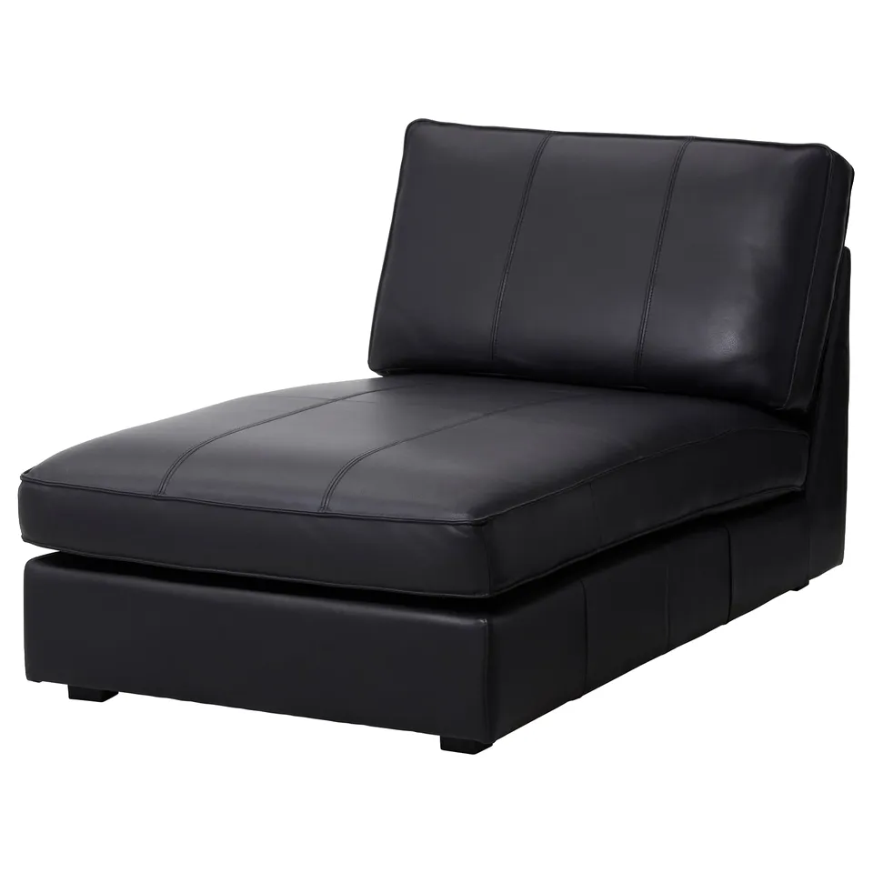 Modern black leather chaise longue; sleek, curved design; plush cushions; stylish for lounging.