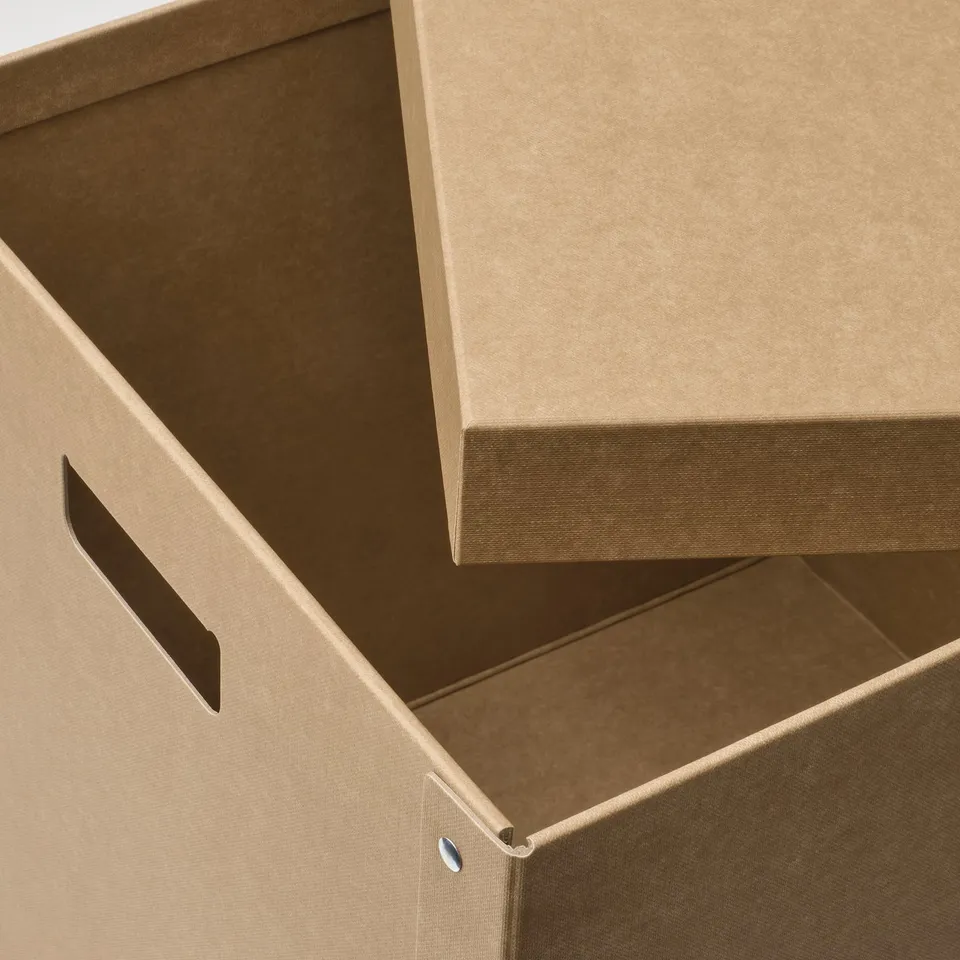 Stacked cardboard storage boxes with handles visible, showcasing sturdy construction and eco-friendly materials.