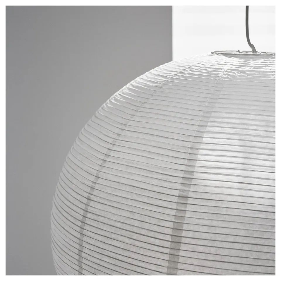 A close-up of a hanging rice paper lamp showcasing its intricate, horizontal layered design, casting soft shadows.