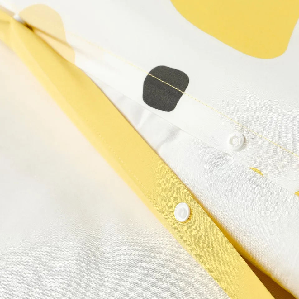 Yellow and white bedsheet with button closure and envelope pillowcase.