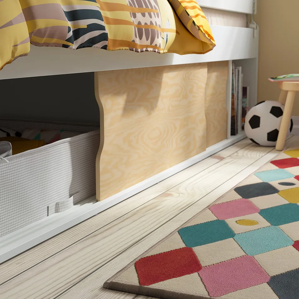 Kids bed with sliding doors and storage under bed. Bright, colourful decor.