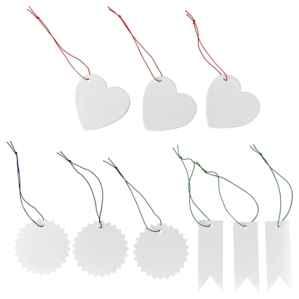Image FÖNSTERFIKUS labels in heart, flower, and ribbon shapes. Labels are white, made of paperboard, attached with colourful elastic strings.