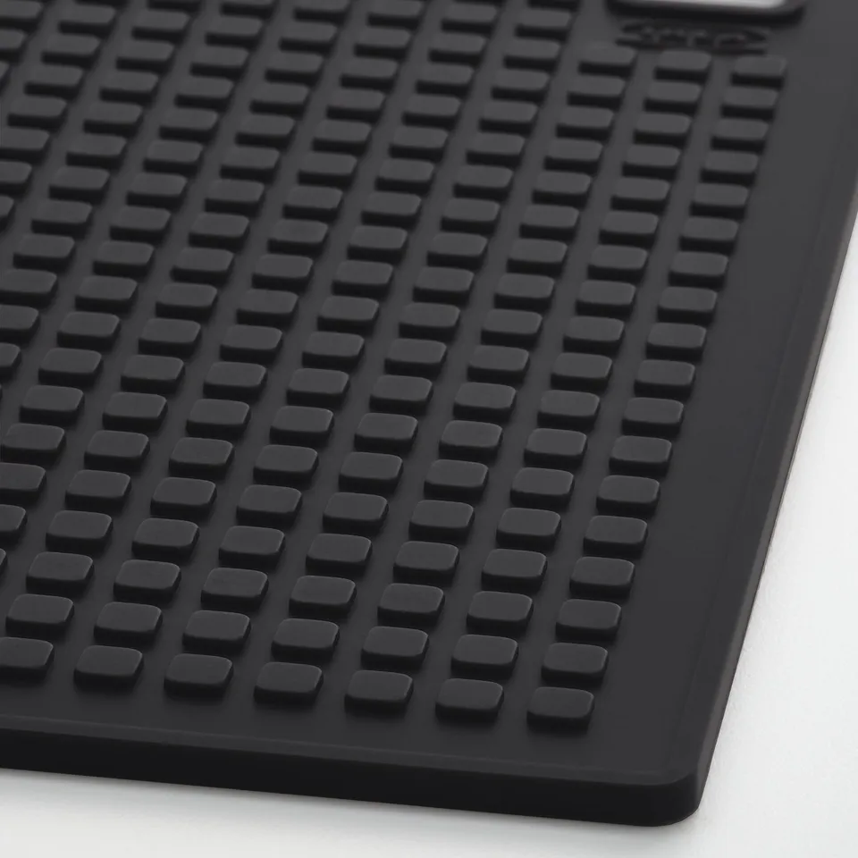 Black silicone mat with square patterns; durable, heat-resistant, and grippy.