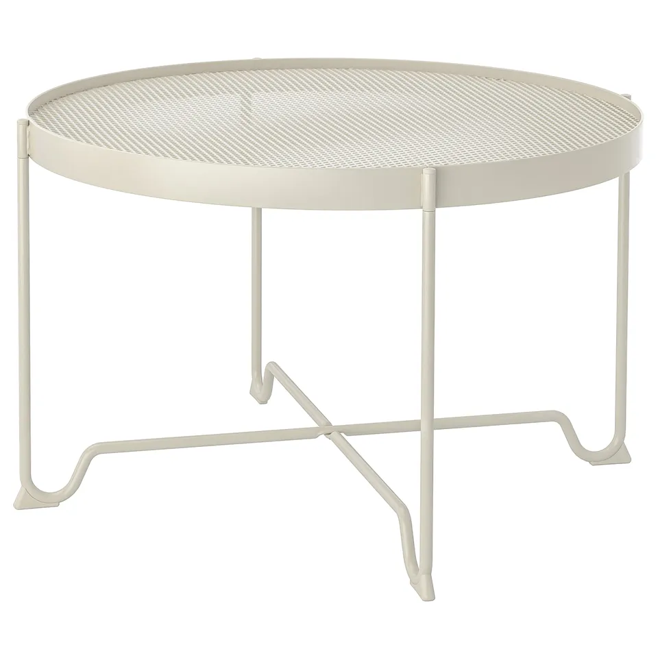 KROKHOLMEN beige metal coffee table, round mesh top, four legs.