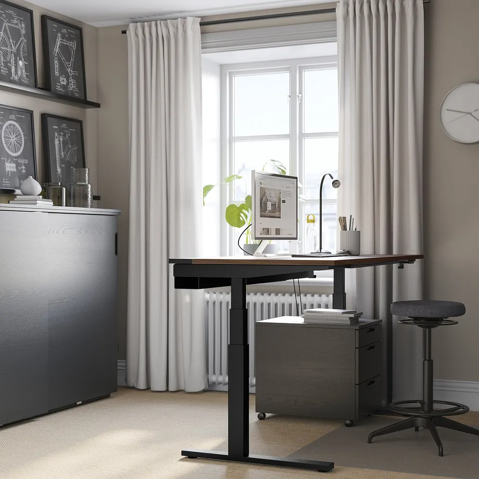 Modern home office setup: MITTZON adjustable desk, black and wood, large monitor, sleek chair. Curtains frame large window.