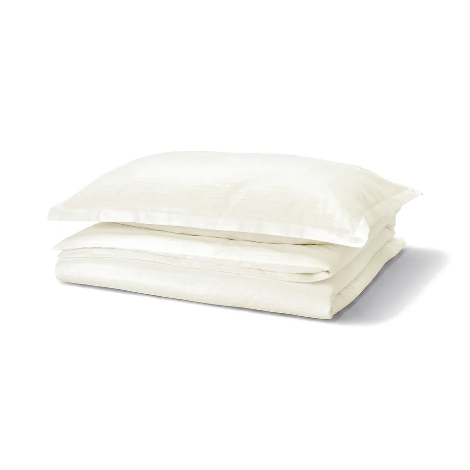 Folded white waffle weave cotton duvet cover set, crisp and clean.