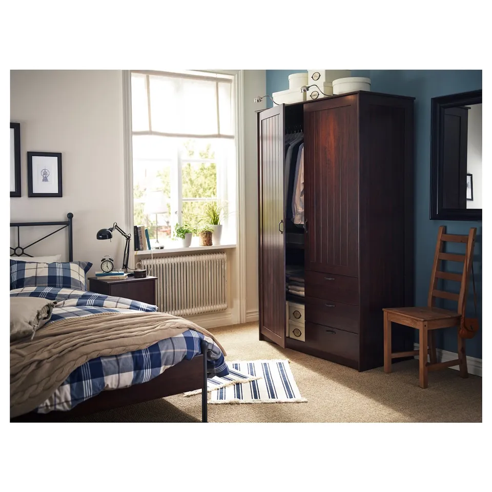 Bedroom with dark wood MUSKEN wardrobe, blue check bedding, wooden chair, blue walls, and large window.