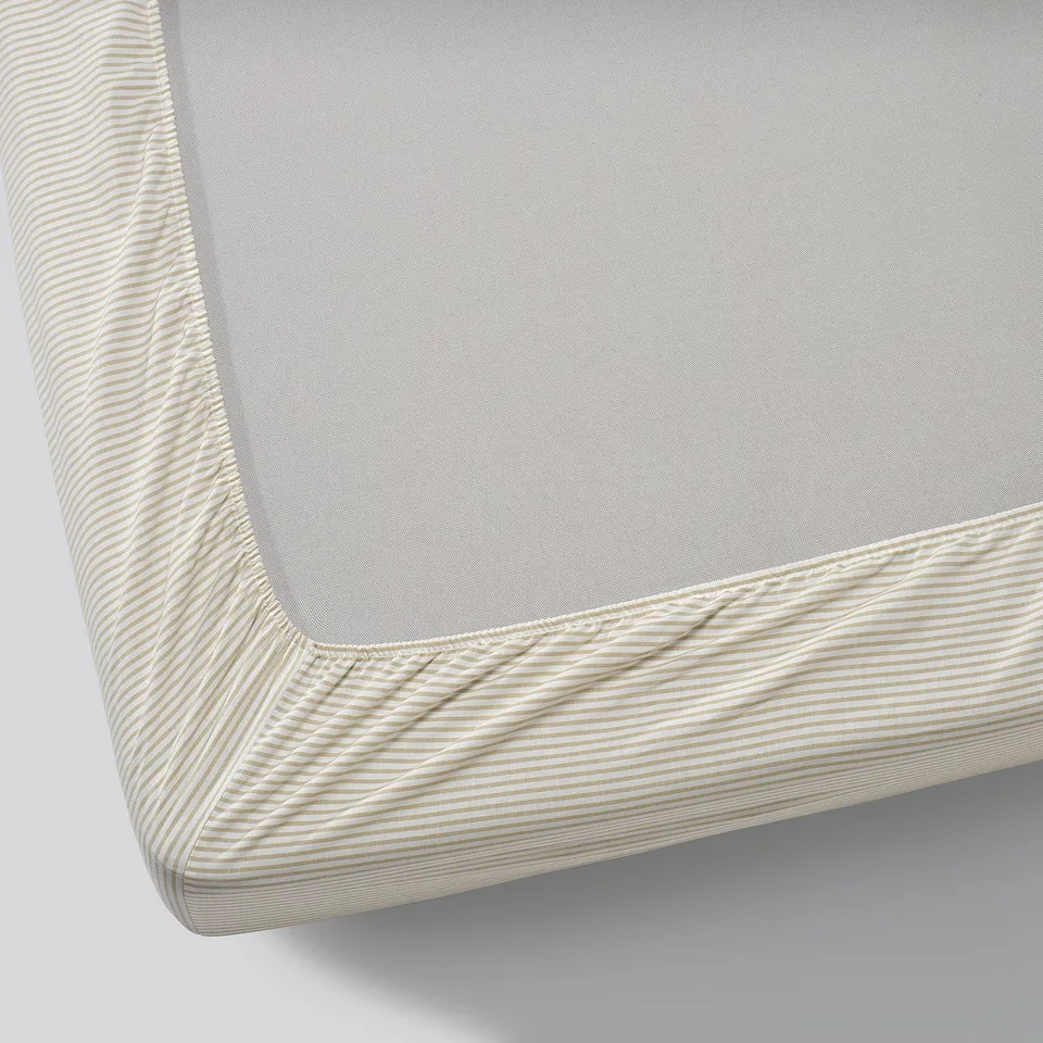 A close-up of a high-quality, textured cotton fitted sheet with elastic edges.