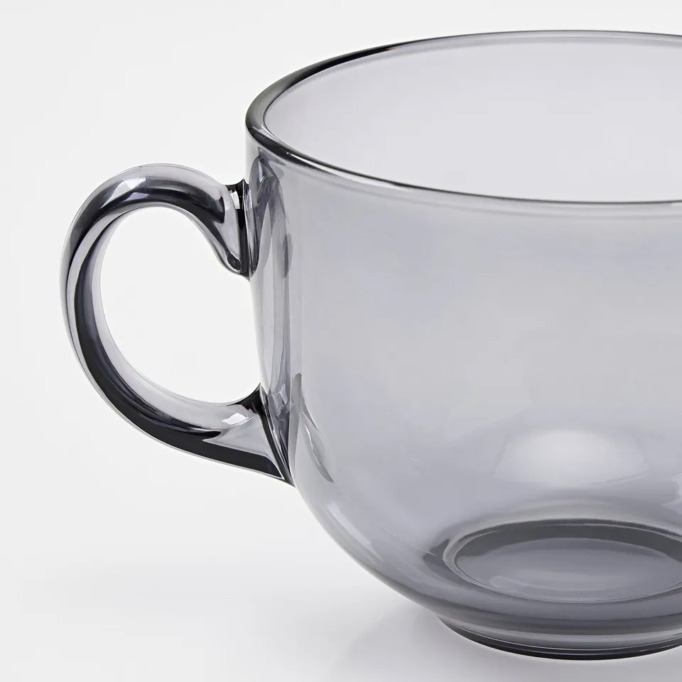 Large glass mug with sturdy handle, part of the HÖSTAGILLE collection, designed for comfort and durability.