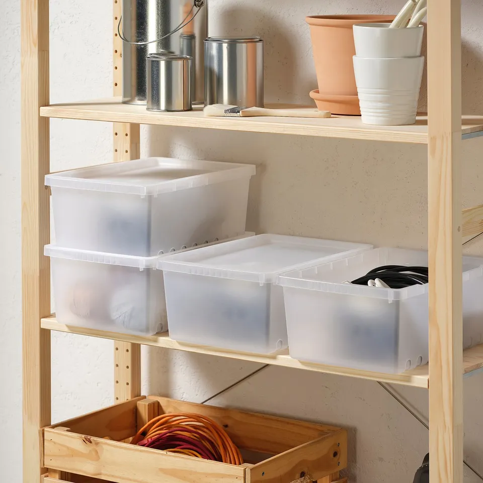 Shelf with clear plastic UPPSNOFSAD boxes and other items.