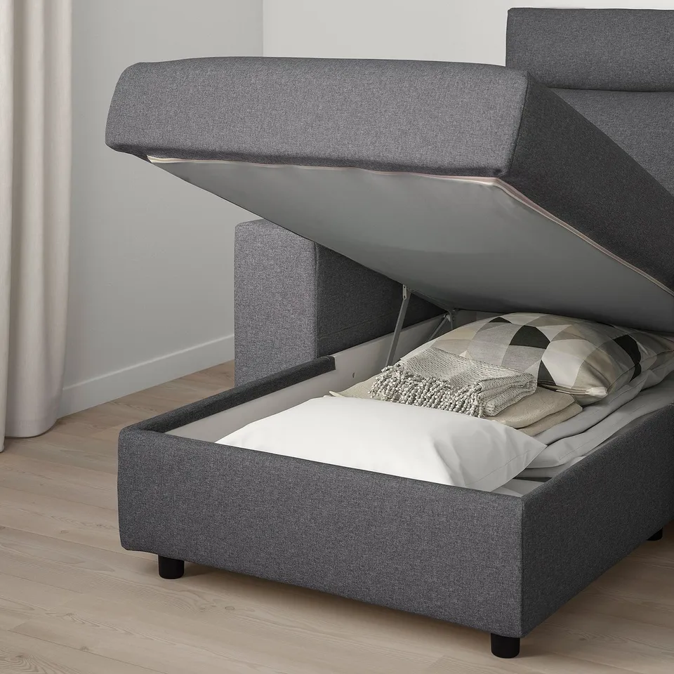 Modern sofa with storage ottoman, open for access.