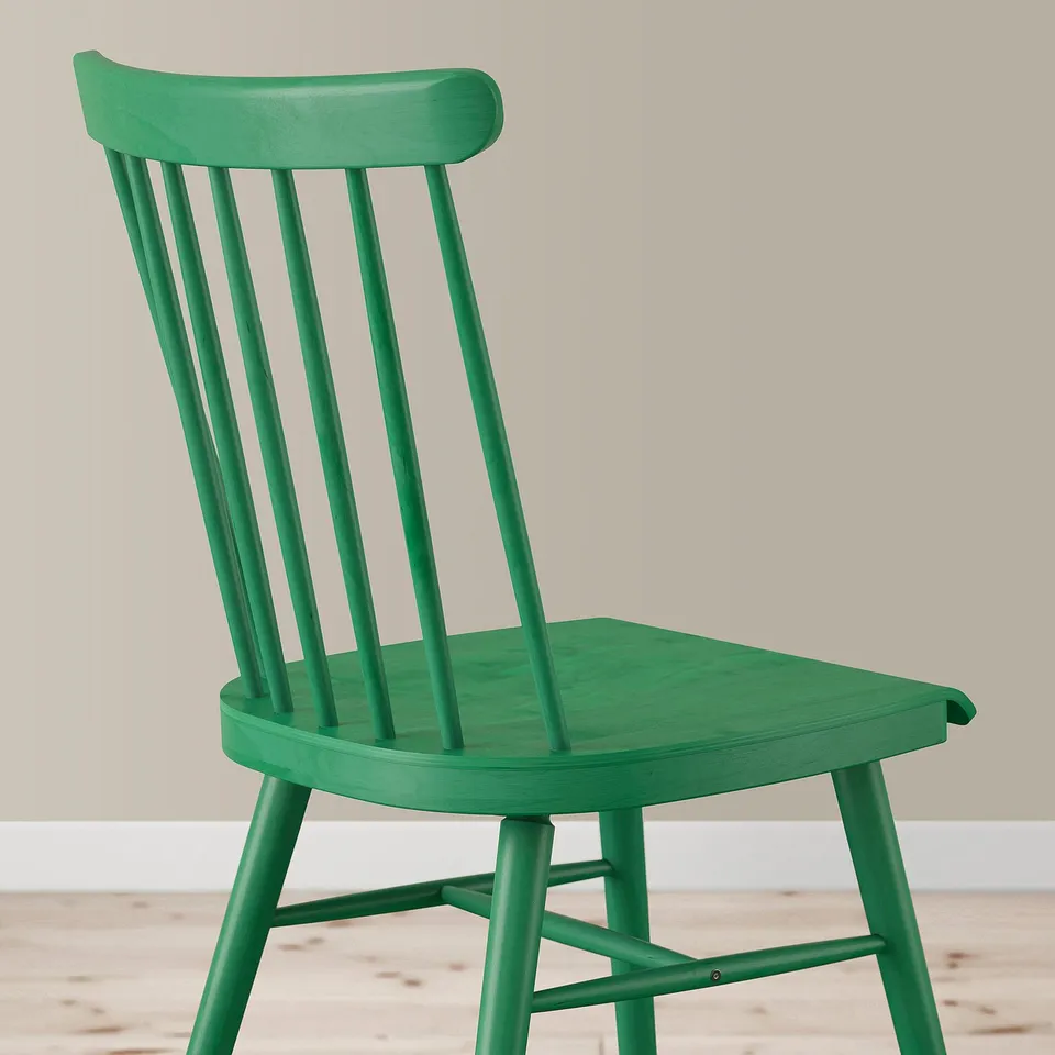 Bright green chair with smooth, sturdy wood finish. Spindle backrest, comfortable seat, sturdy legs.