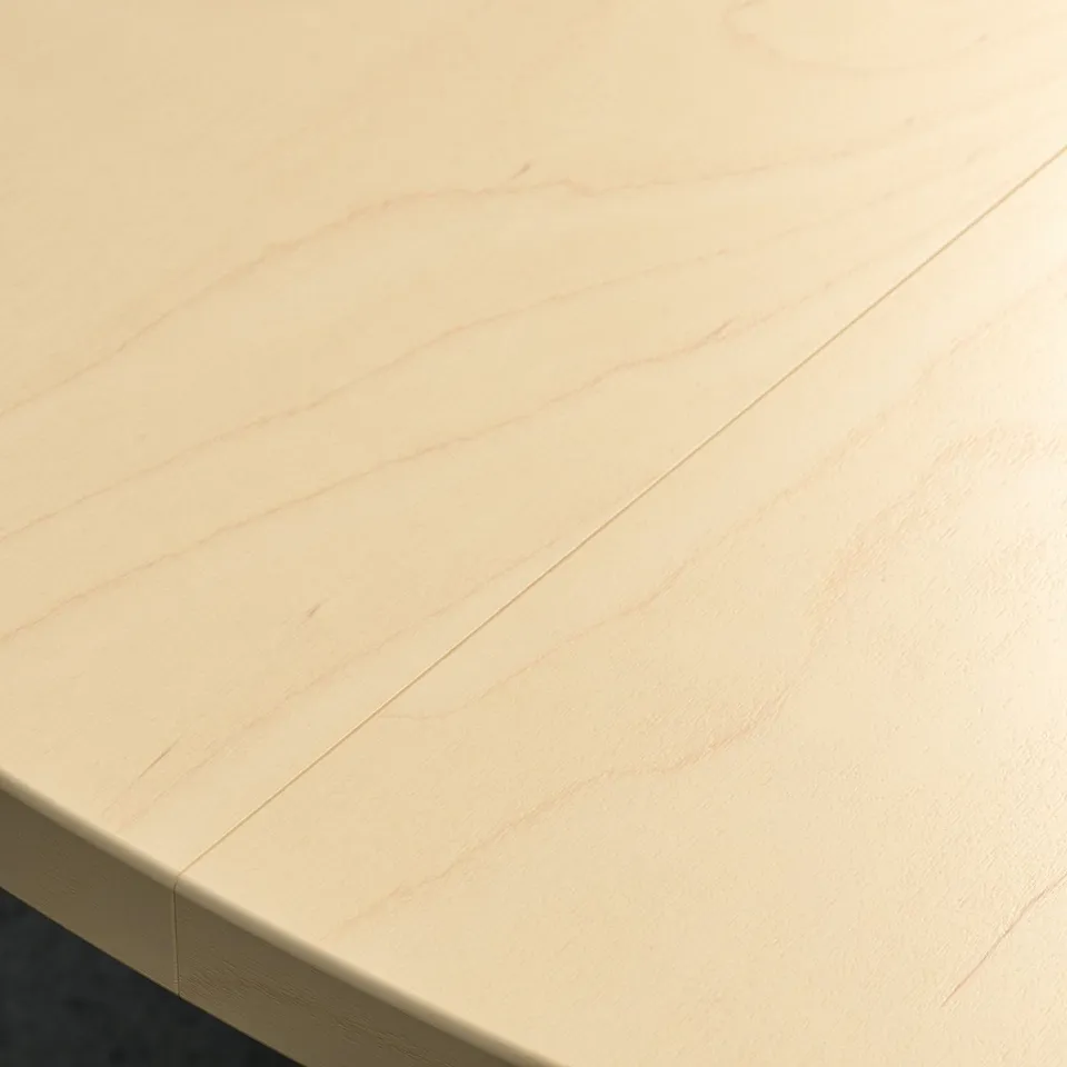 Smooth, light-colored round wooden conference table.