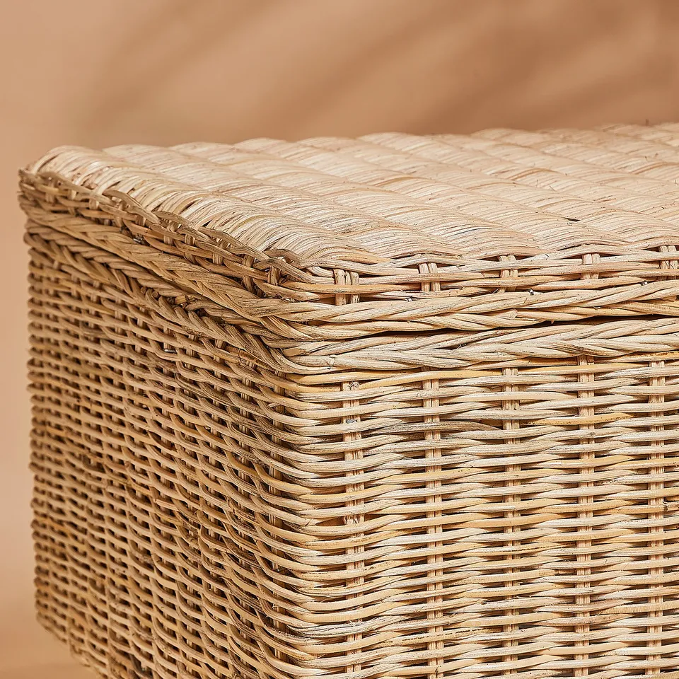 Handwoven wicker basket with tight, neat weave, showing high-quality craftsmanship and natural texture.