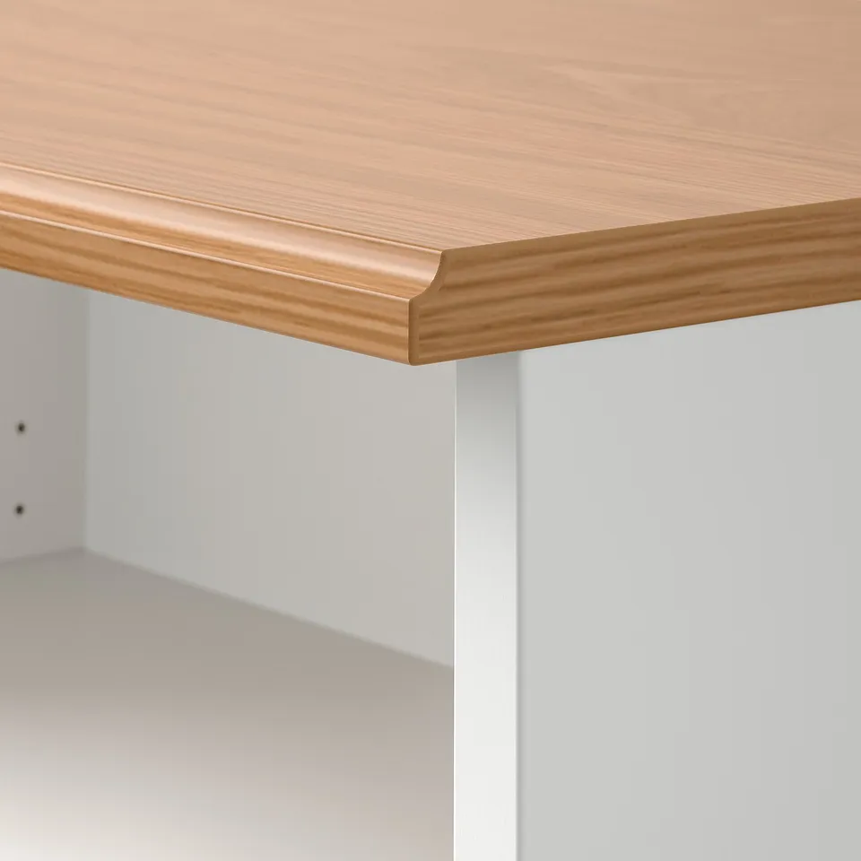 Close-up of light wood table edge, showcasing smooth finish and sturdy construction.