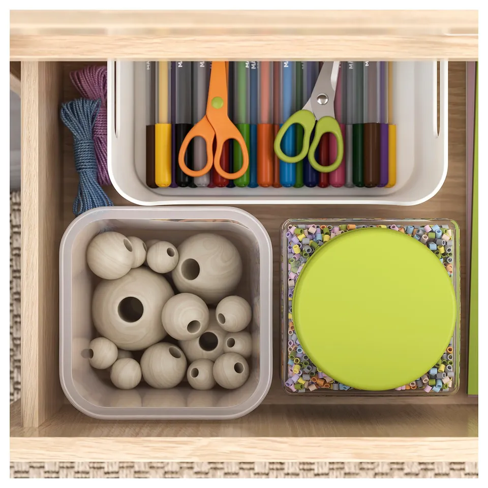 Organised craft drawer with beige wooden beads, colourful markers, and a lime green lid, neatly arranged in storage boxes.