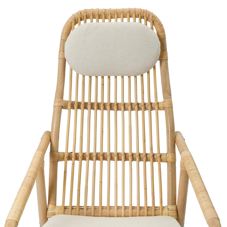 Rattan armchair with soft cushions. Comfortable seats and backs, woven for breathability.