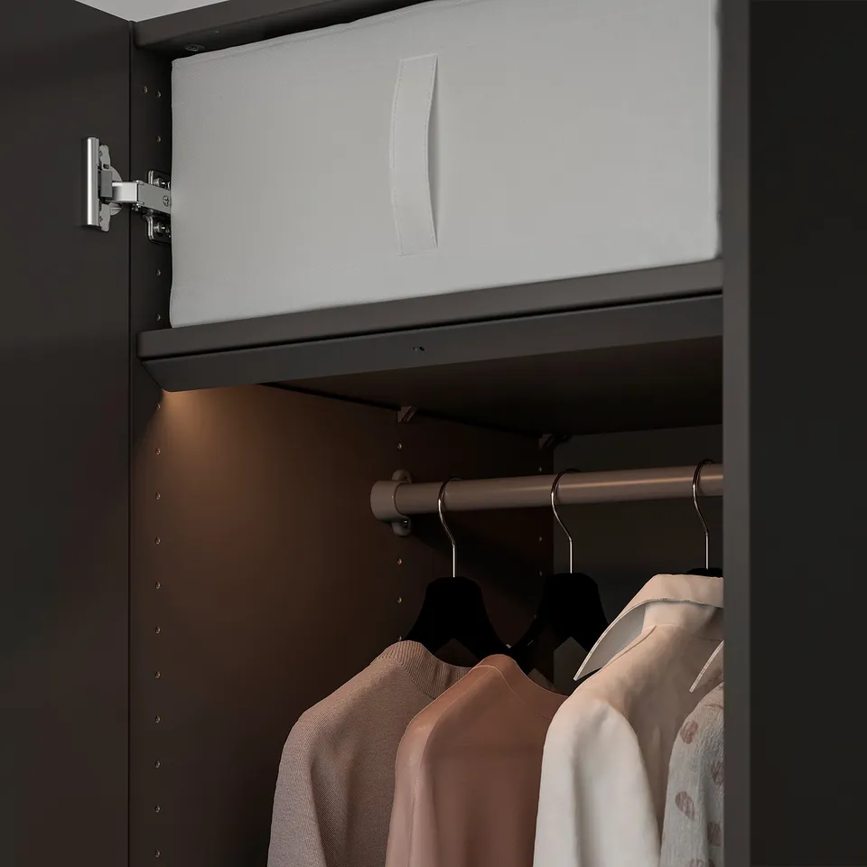 Open drawer with led light, clothes below.