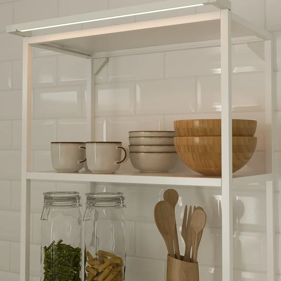 Shelf with lights, bowls, cups, jars, utensils.