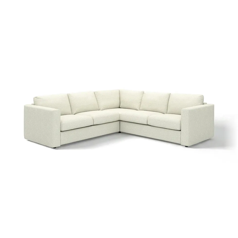 A VIMLE sectional sofa in white tweed. It has a modern, boxy design with a comfortable, low-profile. Ideal for contemporary living rooms.