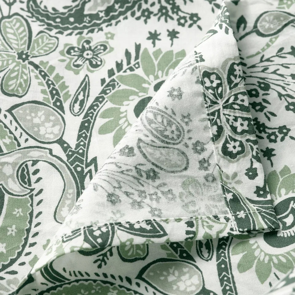 Green and white paisley patterned bedsheet, soft cotton-viscose blend shown folded neatly.