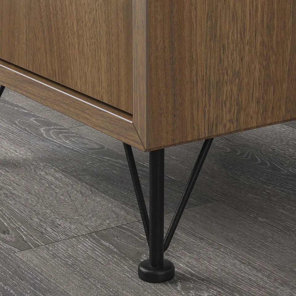 Black metal legs support a wooden cabinet with sleek edges, creating a modern, high-quality look. Legs adjust for uneven floors.