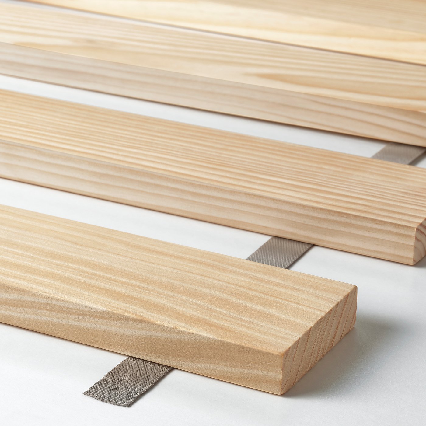 High-quality wooden bed slats, neatly arranged for assembly.